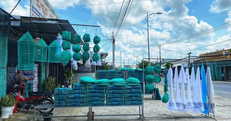 Thom Rom villagers sell fishing net along the road