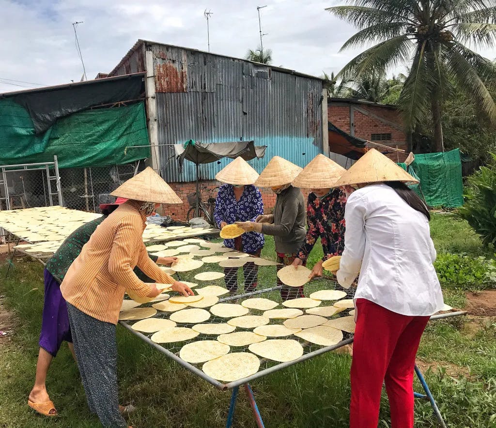 Women are arranging rice paper to dry